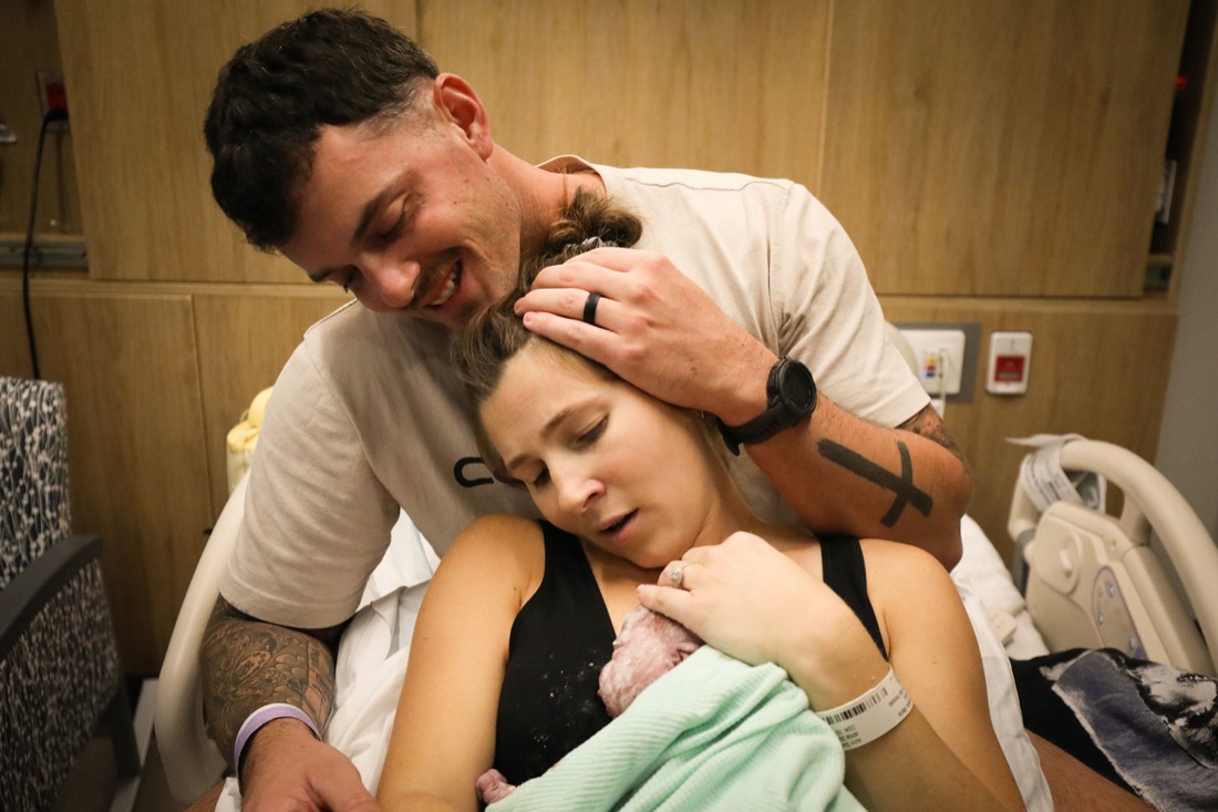 A newborn resting skin to skin with a parent in the first moments after birth in Orange County